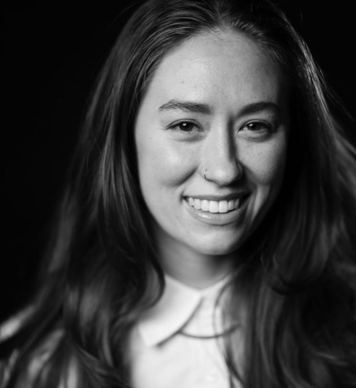 bookish freelance copywriter smiling in black and white photo